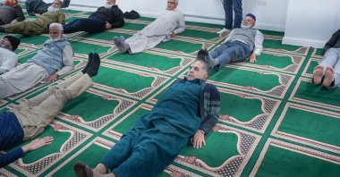 Elderly men doing exercises after prayers at Jamia Usmania Mosque, Bradford, U.K., Feb. 5, 2026. (AA Photo)