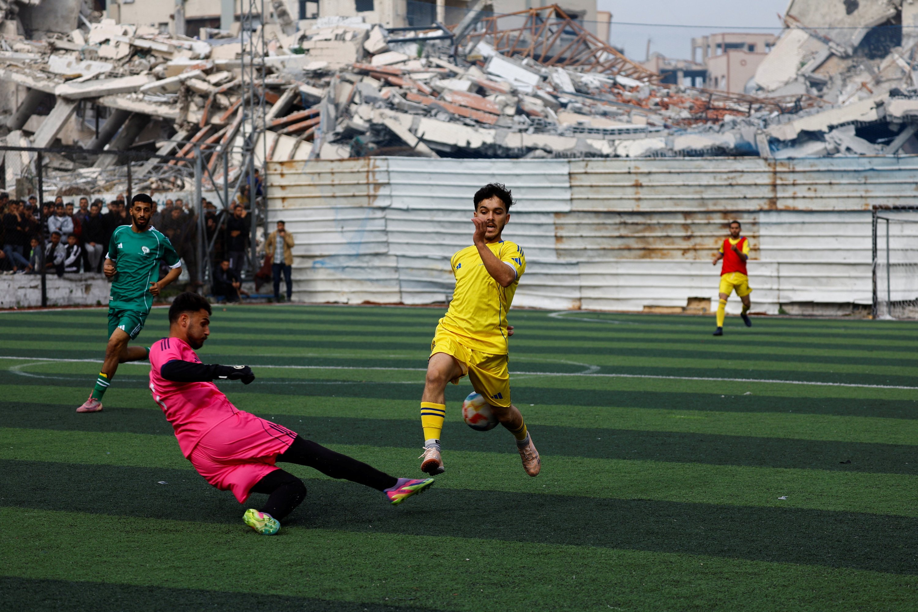 Palestinian football players take part in a friendly five-a-side tournament on a pitch surrounded by buildings destroyed during a two-year Israeli offensive, Gaza City, Palestine, Feb. 9, 2026. (Reuters Photo)