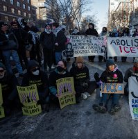 People hold signs as they block a road in an act of civil disobedience outside Columbia University during an anti-ICE protest in New York, New York, Feb. 5, 2026. (EPA Photo)