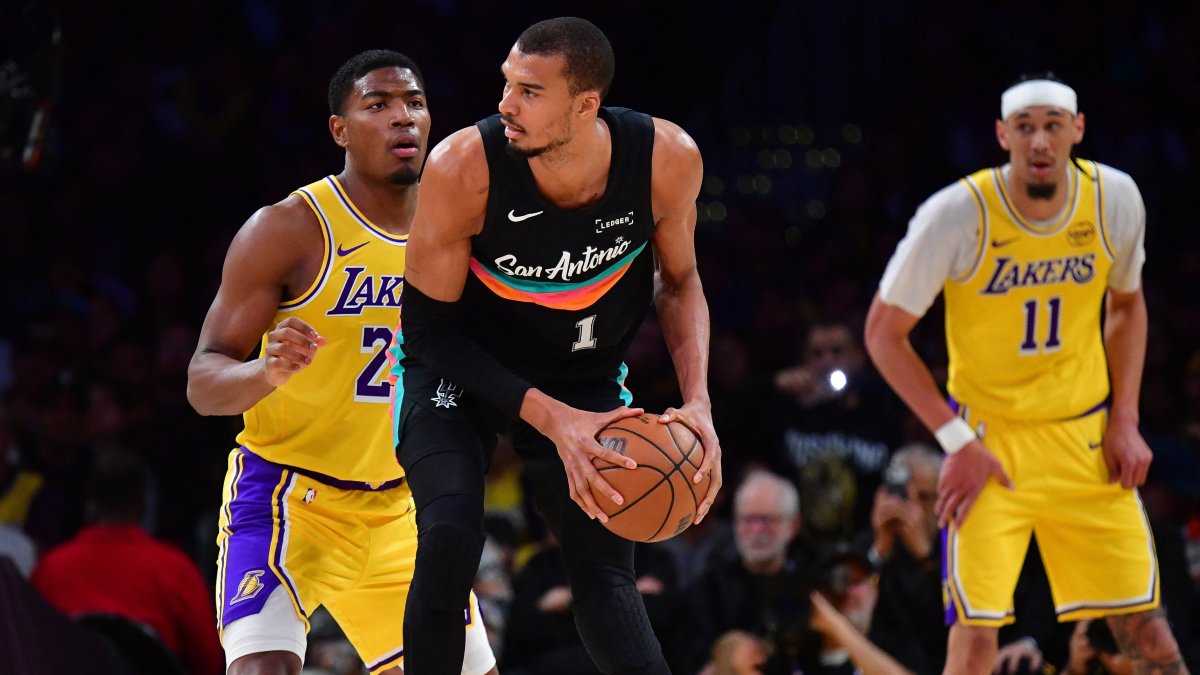 San Antonio Spurs forward Victor Wembanyama (C) moves the ball against Los Angeles Lakers forward Rui Hachimura (L) during the first half at Crypto.com Arena, Los Angeles, U.S., Feb. 10, 2026. (AP Photo)
