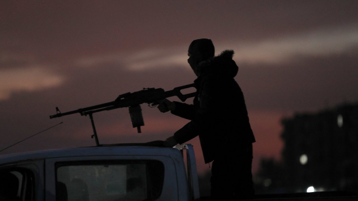 A YPG terrorist rides on top of a vehicle, Hassakeh, Syria, Feb. 10, 2026. (Reuters Photo)