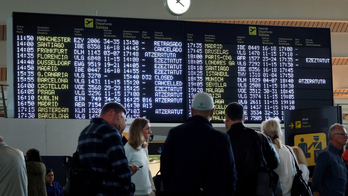 Passengers stand near information panels at Bilbao Airport, Loiu, Spain, Oct. 9, 2024. (Reuters Photo)