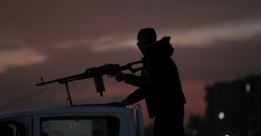 A YPG terrorist rides on top of a vehicle, Hassakeh, Syria, Feb. 10, 2026. (Reuters Photo)