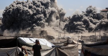 Smoke billows near tents sheltering displaced Palestinians after Israeli bombardment destroys a building called Bab Al Bahr Tower in Gaza City, Palestine, Sept. 10, 2025. (Getty Images)
