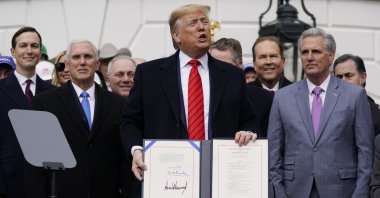President Donald Trump stands after signing a new North American trade agreement with Canada and Mexico, during an event at the White House, Washington DC, U.S., Jan. 29, 2020. (AP Photo)