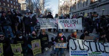 People hold signs as they block a road in an act of civil disobedience outside Columbia University during an anti-ICE protest in New York, New York, Feb. 5, 2026. (EPA Photo)