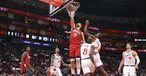Houston Rockets' Alperen Şengün (C) dunks the ball as Los Angeles Clippers forward Kawhi Leonard (2nd R) defends during the third quarter at Toyota Center, Houston, U.S., Feb. 10, 2026. (Reuters Photo)