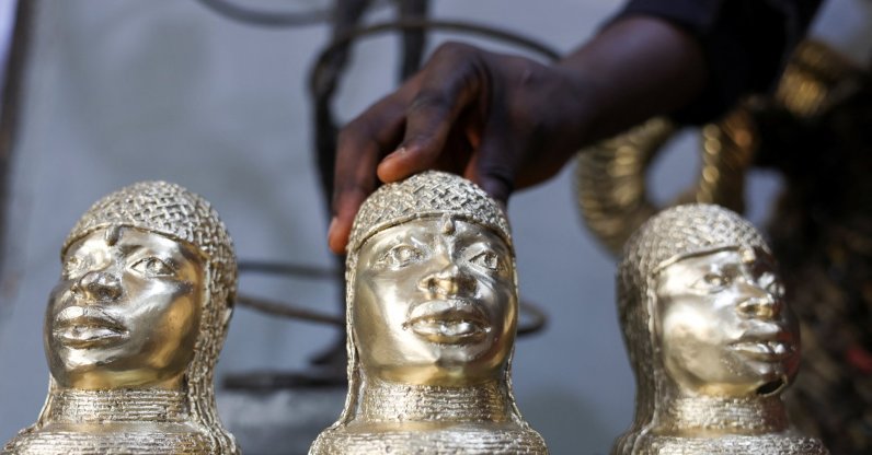 Bronze caster Kelly Omodamwen, 32, from a family of casters, displays sets of Benin bronze pieces at his workshop in Benin City, Edo State, Nigeria, Feb. 2, 2026. (Reuters Photo)