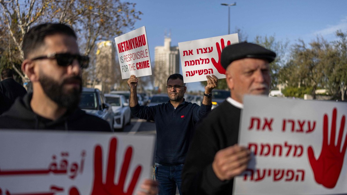 Protesters hold placards, calling on the government to take action to curb soaring violent crime against Arab Israeli communities, West Jerusalem, Feb. 8, 2026. (AFP Photo)
