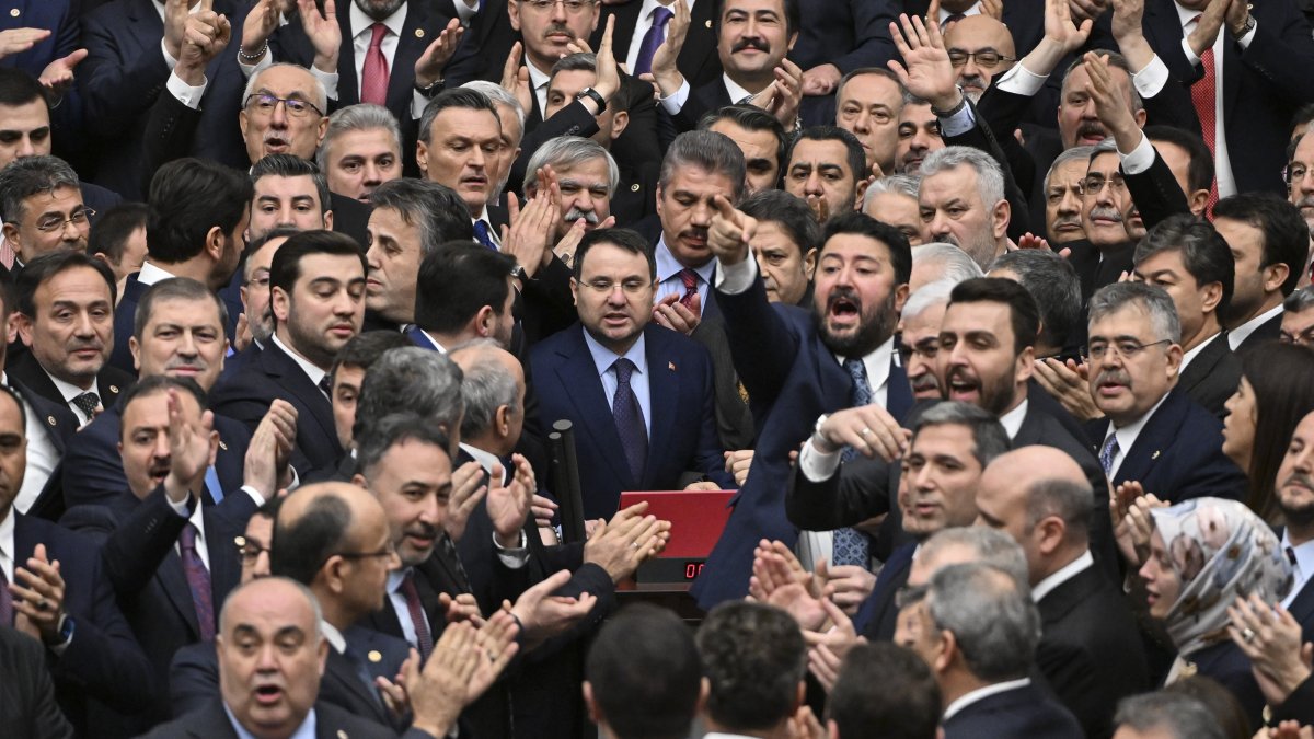 AK Party lawmakers protect newly appointed Justice Minister Akın Gürlek (C) as he takes an oath at Parliament, Ankara, Türkiye, Feb. 11, 2026. (AA Photo)