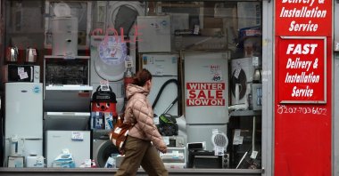 A pedestrian walks past a small business, London, U.K., Feb. 11, 2026. (EPA Photo)