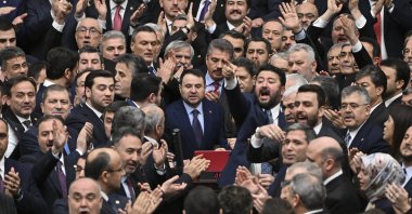 AK Party lawmakers protect newly appointed Justice Minister Akın Gürlek (C) as he takes an oath at Parliament, Ankara, Türkiye, Feb. 11, 2026. (AA Photo)