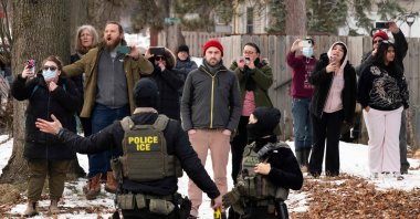 Observers film ICE agents as they hold a perimeter after one of their vehicles got a flat tire on Penn Avenue in Minneapolis, Minnesota, U.S., Feb. 5, 2026. (AFP Photo)