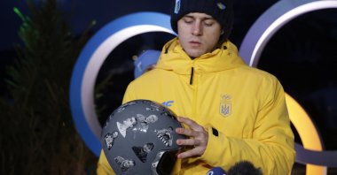 Vladyslav Heraskevych of Ukraine displays his helmet that serves as a tribute to athletes who have died amid Russia's attack on Ukraine during a press conference, Cortina d'Ampezzo, Italy, Feb. 10, 2026. (Reuters Photo)
