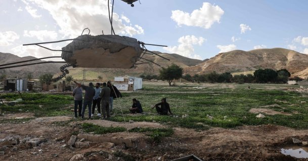 Palestinian residents stand in front of the rubble of a house that was reportedly demolished by Israeli settlers the previous day in a village in the occupied West Bank, Palestine, Feb. 11, 2026. (AFP Photo)