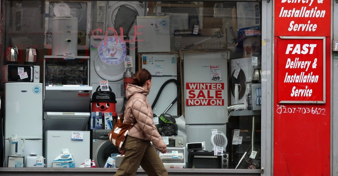 A pedestrian walks past a small business, London, U.K., Feb. 11, 2026. (EPA Photo)