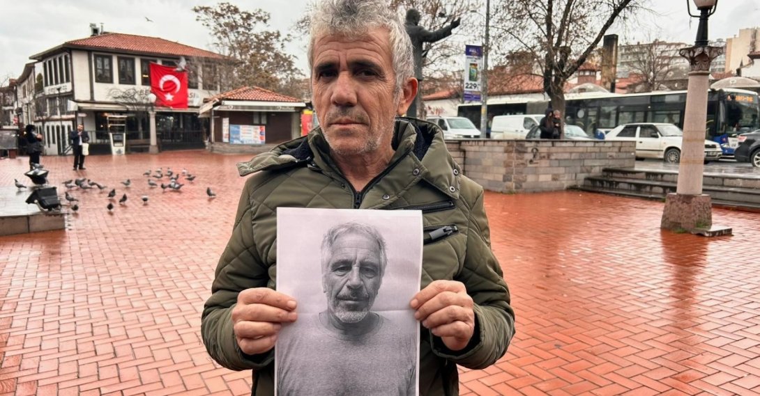 Rıfat Özdemir poses with a photo of Jeffrey Epstein in Ankara, where he recently relocated after leaving his hometown of Kayseri following a viral social media comparison, Türkiye, Feb. 12, 2026. (IHA Photo)