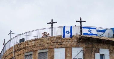 Crosses and Israeli flags hang on the roof of a building, Haifa, Israel, Dec. 26, 2022. (Shutterstock Photo)
