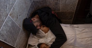 Father of the two girls mourns beside their bodies inside Nasser Hospital following an Israeli airstrike that targeted a camp sheltering displaced people west of Khan Younis in the southern Gaza Strip, Feb. 4, 2026. (EPA Photo)