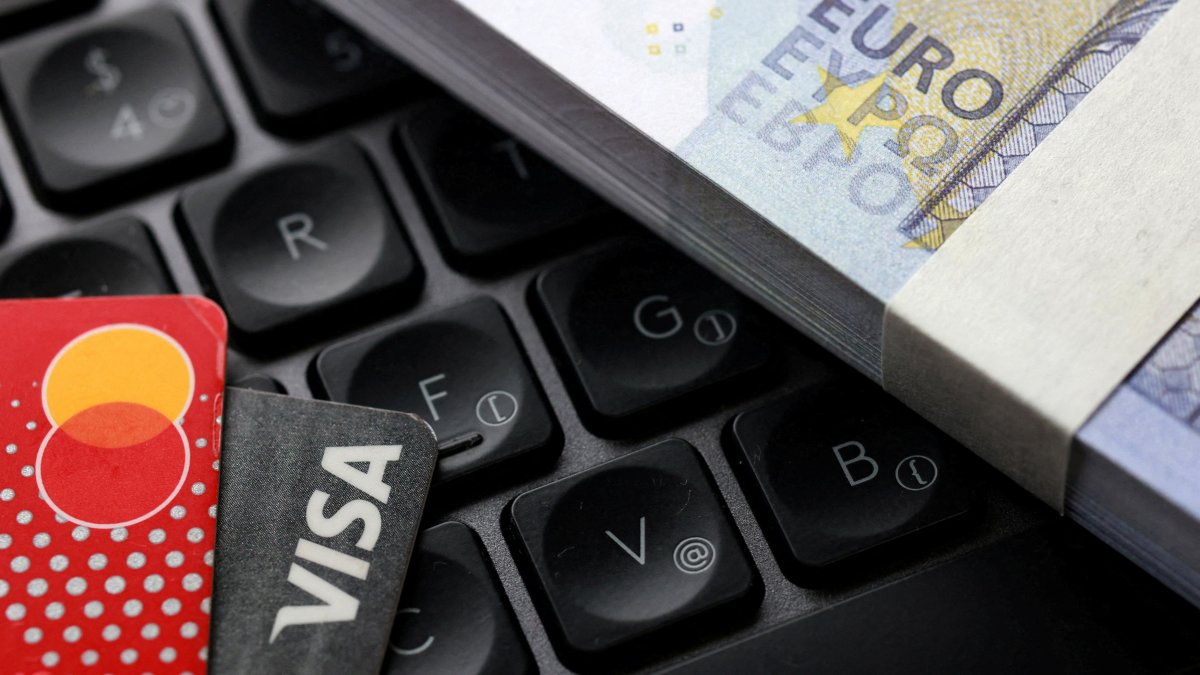 Euro banknotes, Visa and Mastercard cards are placed on a keyboard in this illustration taken on Sept. 24, 2025. (Reuters Photo)