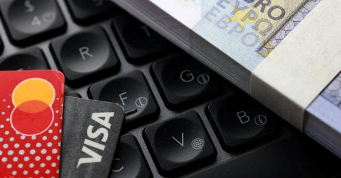 Euro banknotes, Visa and Mastercard cards are placed on a keyboard in this illustration taken on Sept. 24, 2025. (Reuters Photo)