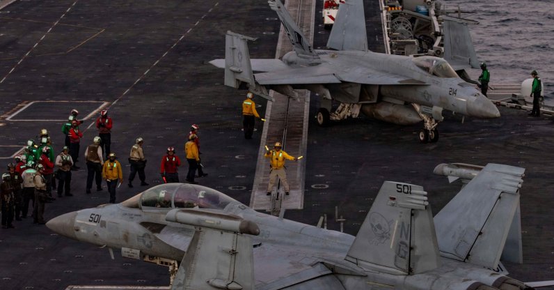 U.S. sailors direct an EA-18G Growler on the flight deck of Nimitz-class aircraft carrier USS Abraham Lincoln in the Arabian Sea, Feb. 3, 2026. (AFP Photo)