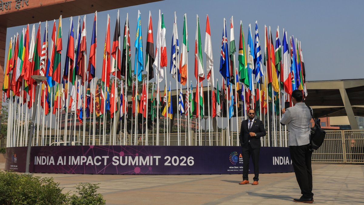Visitors take photographs next to the flags of participating nations outside the AI Impact Summit 2026 venue at Bharat Mandapam, New Delhi, India, Feb. 16, 2026. (EPA Photo)