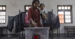 A woman casts her vote at a polling center during the 2026 general election in Dhaka, Bangladesh, Feb. 12, 2026. (AA Photo)