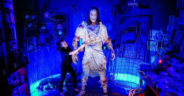 Charlotte Mullen adds the finishing touches to the huge 8-foot (2.4m) tall creature from the gothic horror novel "Frankenstein," at the world's first attraction dedicated to the book's author, Mary Shelley, inside the Mary Shelley's House of Frankenstein experience, Bath, U.K., July 14, 2021. (Getty Images Photo)