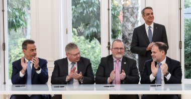 From left, Greek Environment and Energy Minister Stavros Papastavrou, Helleniq Energy CEO Andreas Shiamishis, Chevron Vice President New Ventures Gavin Lewis, and Hellenic Hydrocarbon Resources Management S.A. CEO Aristofanis Stefatos and Greek Prime Minister Kyriakos Mitsotakis applaud after signing Chevron-led consortium contracts for gas exploration off Greece, Athens, Greece, Feb. 16, 2026. (Reuters Photo)