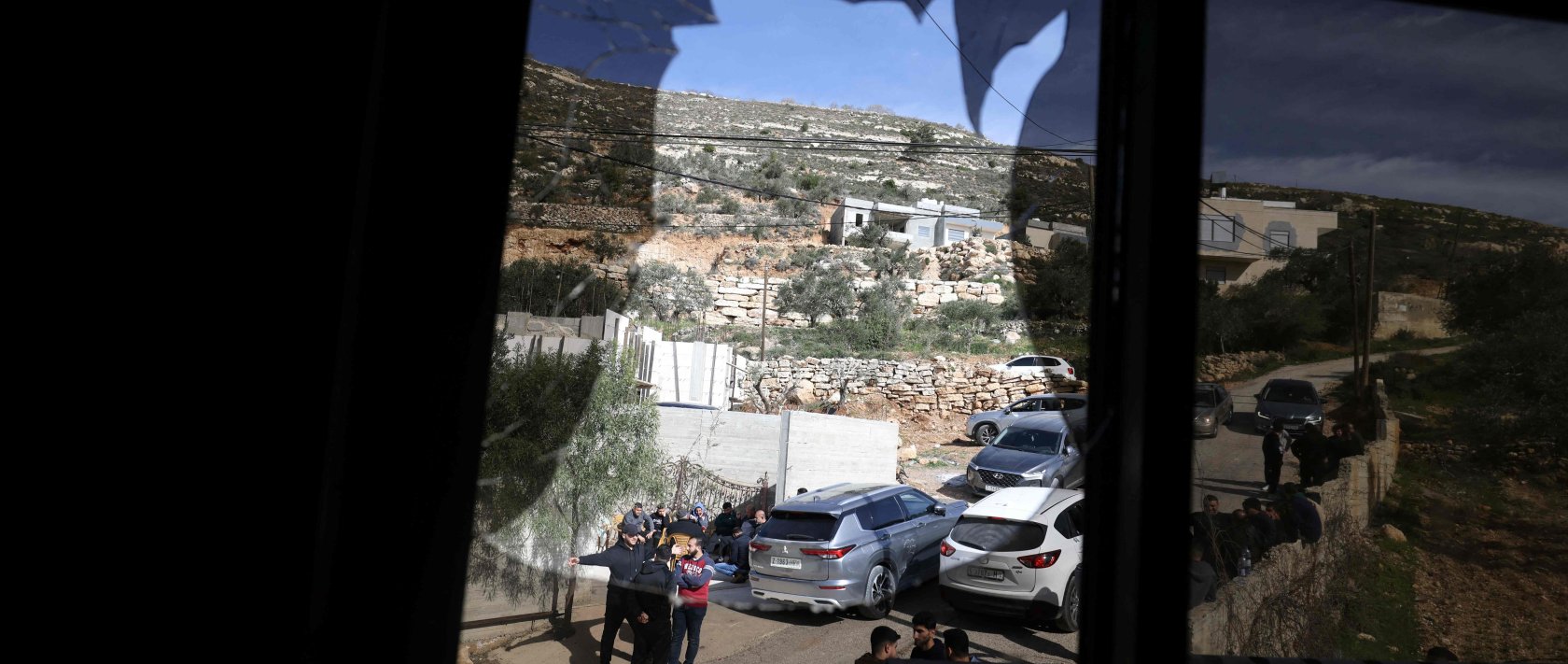 A shattered window overlooks a street after it was broken when Jewish settlers vandalised vehicles and homes in the Palestinian village of Telfit, south of the Israeli-occupied West Bank city of Nablus, Feb. 13, 2026. (AFP Photo)