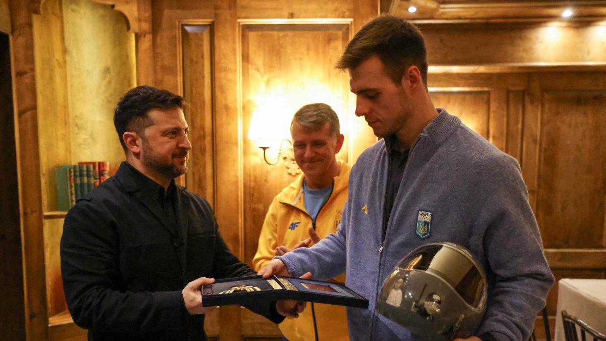 Ukrainian President Volodymyr Zelensky awards Ukrainian skeleton athlete Vladyslav Heraskevych a medal as they meet, Munich, Germany, Feb. 13, 2026. (AFP Photo)