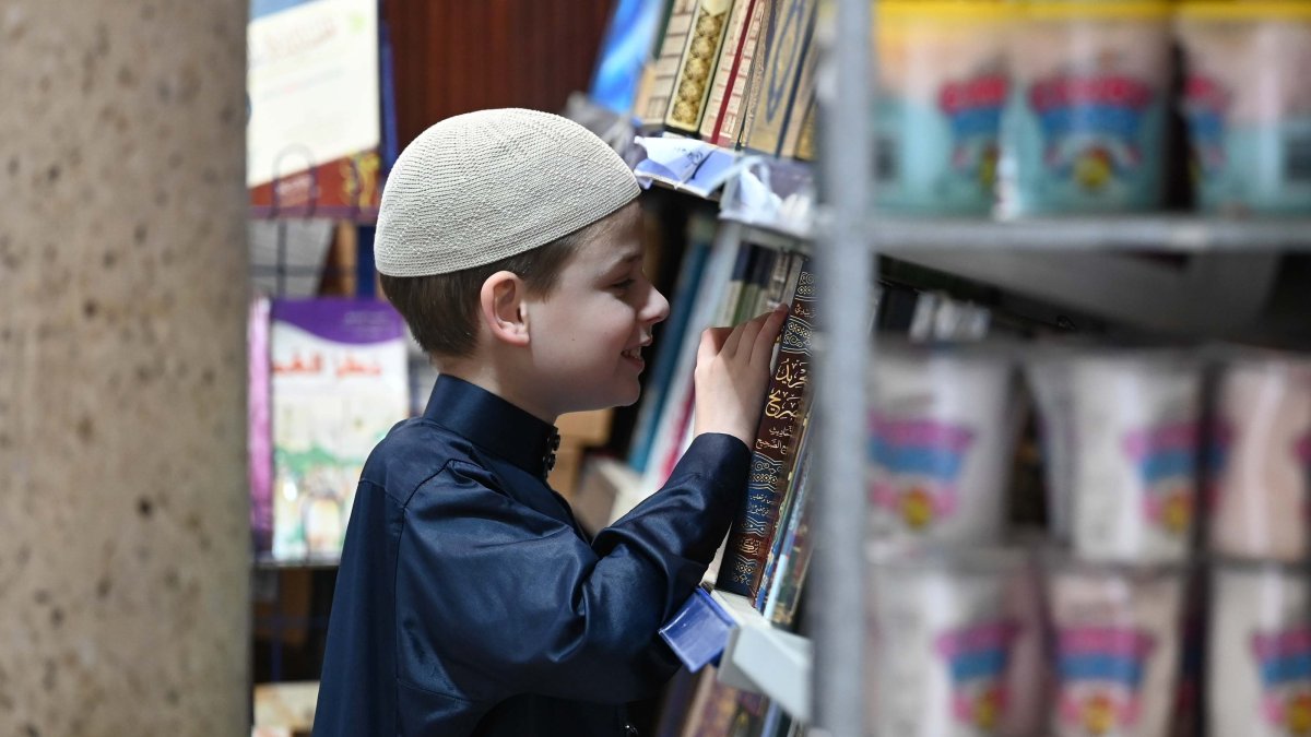 Joshua Harris looks through religious books inside a mosque during one of his visits, Peterborough, U.K., Feb. 7, 2026. (AA Photo)