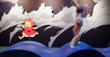 A child plays with an animated character at the Academy Museum Studio Ghibli's PONYO media preview, Los Angeles, U.S., Feb. 12, 2026. (AFP Photo)