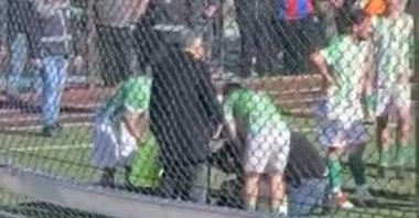 This video grab shows Darendespor and Hekimhan Belediyesi Girmana Spor players checking on referee Hakan Başkurt who had been hit by a scooter after he disallowed a goal for offside, Malatya, Türkiye, Feb. 15, 2026. (DHA Photo)