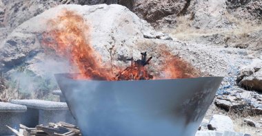A pit filled with weapons turned over by the PKK is set on fire during a ceremony, Sulaimaniyah, northern Iraq, July 11, 2025. (AFP Photo)