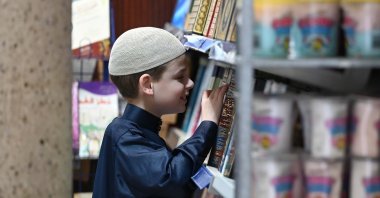 Joshua Harris looks through religious books inside a mosque during one of his visits, Peterborough, U.K., Feb. 7, 2026. (AA Photo)