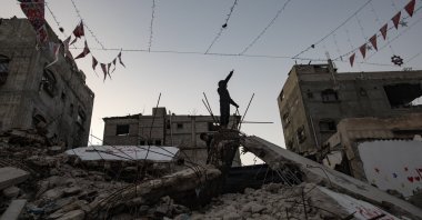 Displaced Palestinians hang decorations over the rubble of their destroyed homes as they prepare to welcome the holy month of Ramadan in Khan Yunis, southern Gaza Strip, Feb. 15, 2026. (EPA Photo)