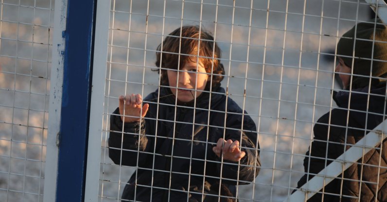Syrian internal security forces stand guard along the fence of al-Hol camp in Hasakeh province, Syria, Jan. 21, 2026. (AFP Photo)