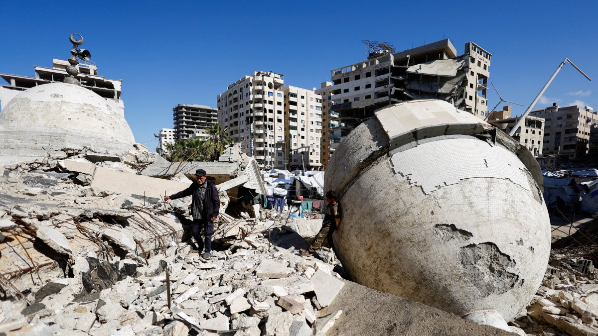 A displaced Palestinian man stands on the rubble of a mosque destroyed during the two-year Israeli offensives, surrounded by tents in Gaza City, Feb. 11, 2026. (Reuters Photo)