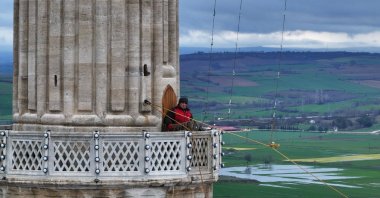 Mahya master Kahraman Yıldız installs an illuminated Ramadan inscription on the minarets of Selimiye Mosque, Edirne, Türkiye, Feb. 18, 2026. (AA Photo)
