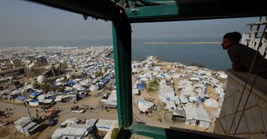 A Palestinian looks at a mosque, destroyed during the two-year Israeli offensives, surrounded by tents for displaced Palestinians, in Gaza City, Feb. 15, 2026. (Reuters Photo)