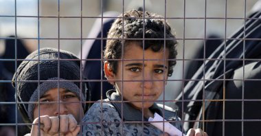 Children, part of a group of detainees, look through a fence at al-Hol camp after the Syrian government took control of it following the withdrawal of Syrian Democratic Forces (SDF), in Hassakeh, Syria, Jan. 21, 2026. (Reuters File Photo)