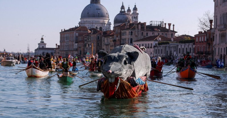 A boat carries a "Pantegana," the big rat, as revelers row during the masquerade parade on the Grand Canal at the Venice Carnival, Venice, Italy, Feb. 1, 2026. (Reuters Photo)