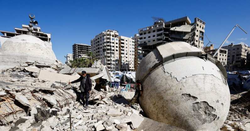 A displaced Palestinian man stands on the rubble of a mosque destroyed during the two-year Israeli offensives, surrounded by tents in Gaza City, Feb. 11, 2026. (Reuters Photo)