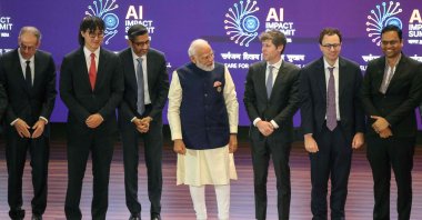 India's Prime Minister Narendra Modi (C) takes a group photo with AI company leaders including OpenAI CEO Sam Altman (3rd R) and Anthropic CEO Dario Amodei (2nd R) at the AI Impact Summit, New Delhi, India, Feb. 19, 2026. (AFP Photo)