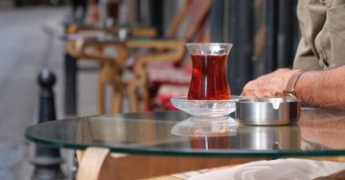 A person drinks traditional Turkish tea at an undisclosed location. (Shutterstock Photo)