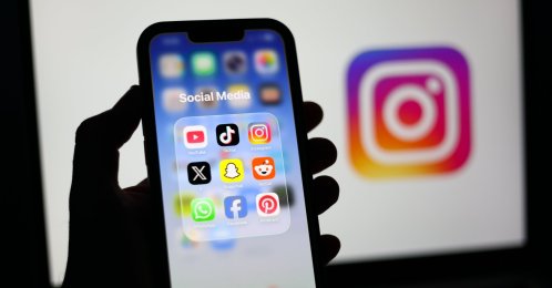 Social media applications are displayed on a mobile phone alongside the Instagram logo on a laptop screen, Liverpool, Britain, Jan. 23, 2026. (EPA Photo)