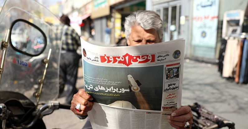 A man reads the Iranian daily newspaper Vatan-e Emrooz featuring a headline "Sea surprises," outside a kiosk in Tehran, Iran, Feb. 19, 2026. (EPA Photo)