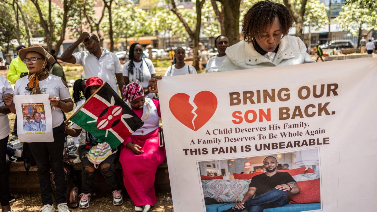 Relatives of Kenyan nationals conscripted by the Russian army in Ukraine pose with photos of their family members during a prayer and peaceful demonstration demanding urgent government action to repatriate their kin, Nairobi, Kenya, Feb. 19, 2026. (AFP Photo)